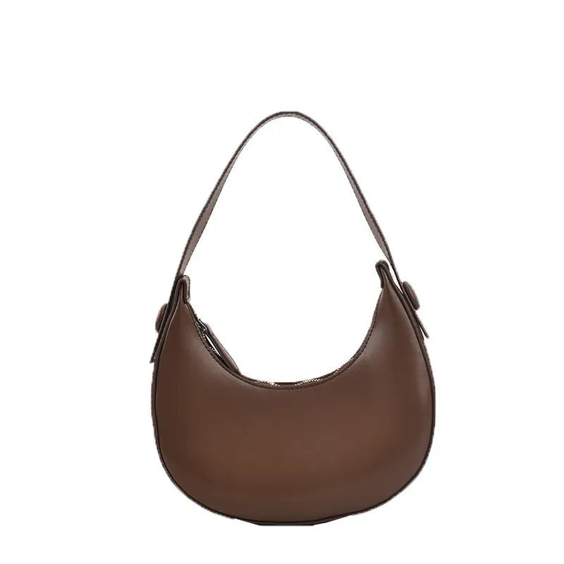 Retro dumpling-shaped black PU leather women's shoulder bag with a front sandwich pocket.