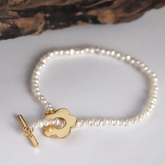 Sterling silver natural pearl flower bracelet with irregular pearl beads, handmade, adjustable size, on a white background