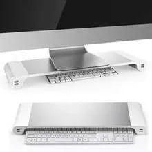 Silver and black computer monitor stand with USB charging ports and hidden keyboard storage compartment