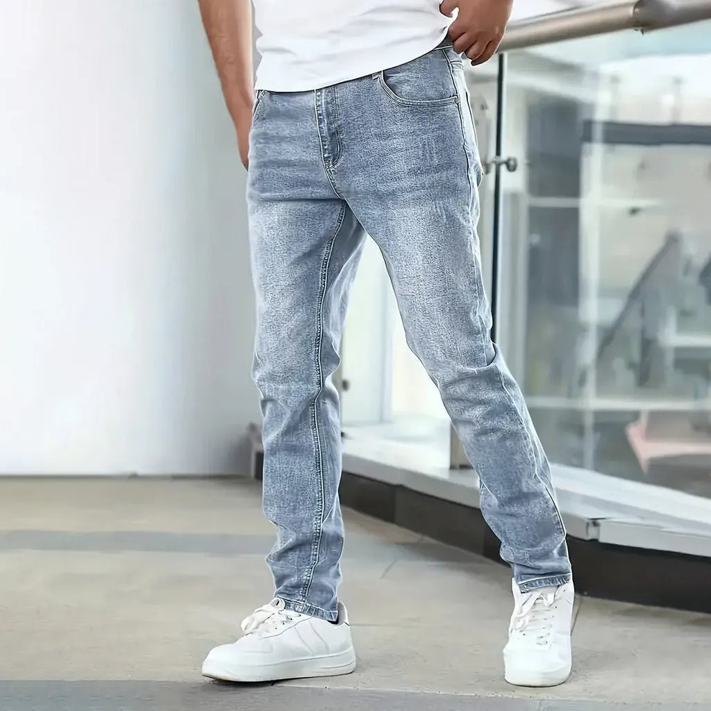 Men's black straight leg skinny stretch jeans with a mid waist and zipper fly.