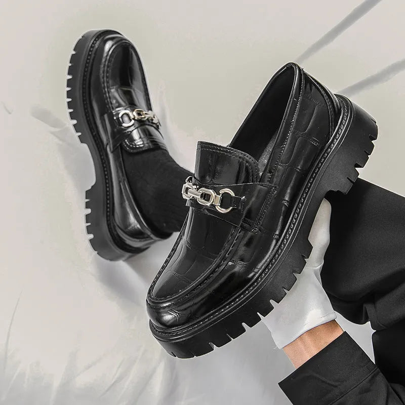 Men's black crocodile pattern leather loafers with a flat heel.