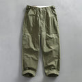 Men's straight leg cotton casual trousers in apricot, shown from the front.