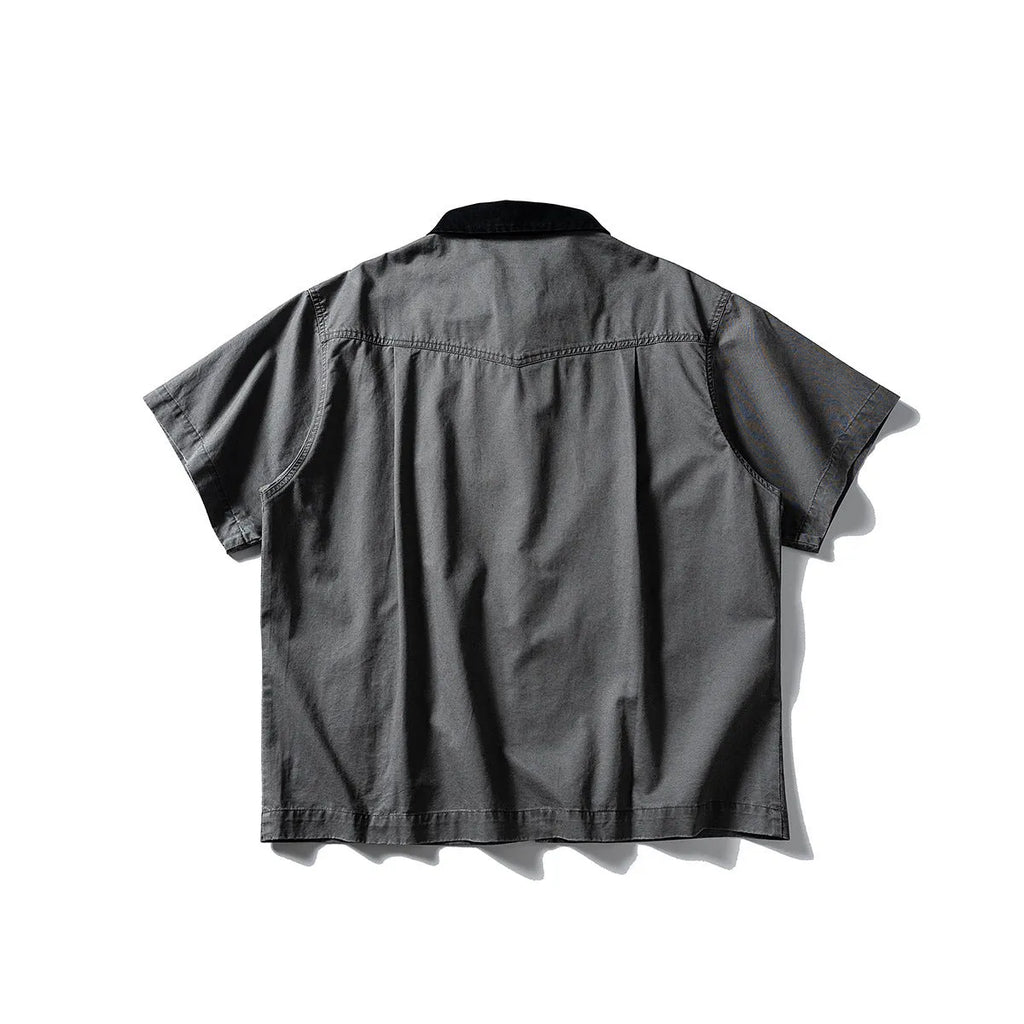 Man wearing a grey washed cotton short sleeve loose cardigan shirt.