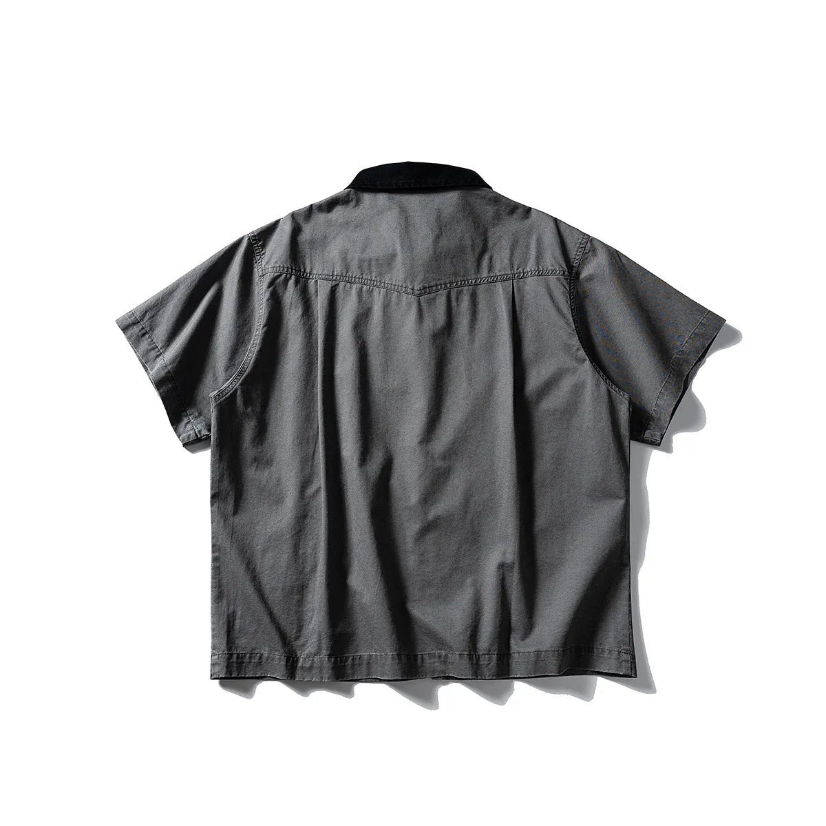 Man wearing a grey washed cotton short sleeve loose cardigan shirt.