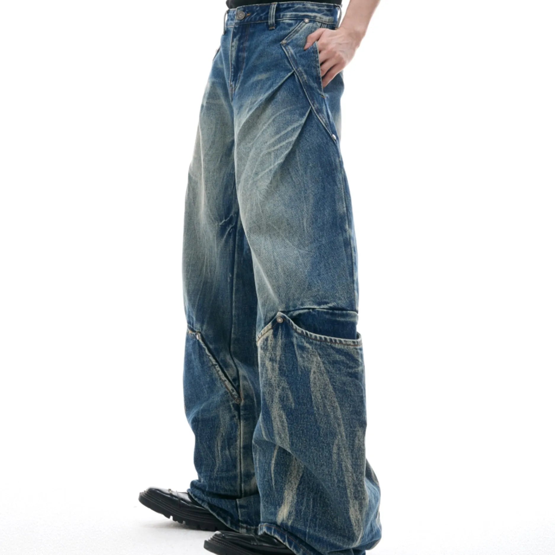 Men's verdant blue jeans with a retro washed burst pattern and curved knife details, shown in a loose fit.