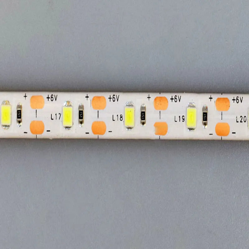 Photon Lighting flexible USB LED light strip bent into a curve showing its adhesive backing and touch control.
