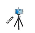 Mini black flexible octopus tripod stand holder with suction cup base holding a smartphone