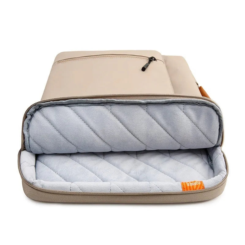 Khaki nylon laptop sleeve with zip closure and visible sewing lines next to a 14-inch notebook