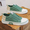 Men's low-top canvas casual shoe in blue with round toe, lace-up front, and soft PVC sole.