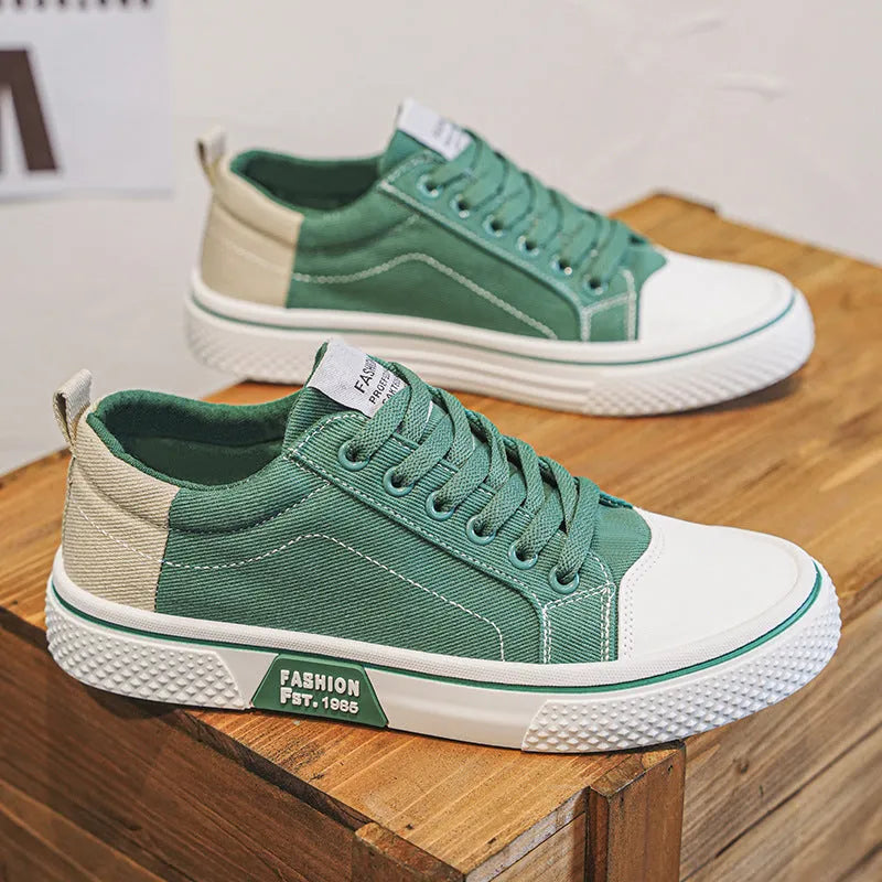 Men's low-top canvas casual shoe in blue with round toe, lace-up front, and soft PVC sole.