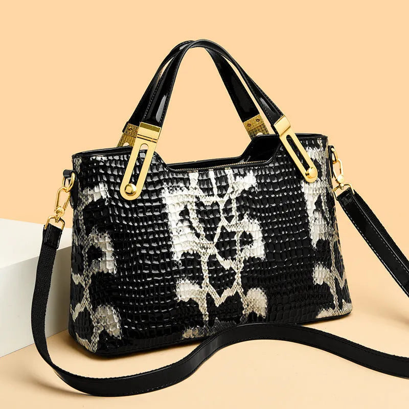 Black retro style shoulder messenger bag with chain detailing and horizontal square silhouette