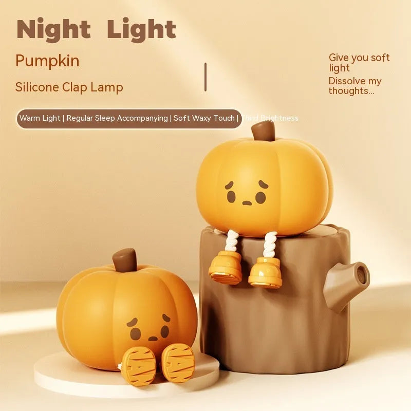 Soft orange silicone pumpkin-shaped night light with a warm glowing LED centre