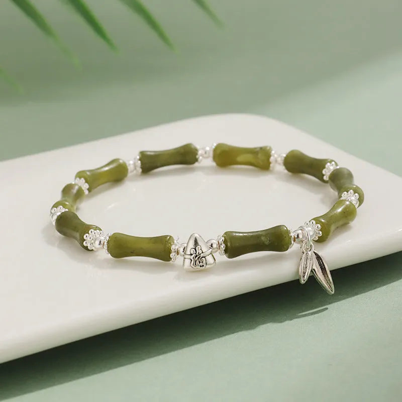 Green aventurine bamboo bead crystal bracelet with strawberry quartz and Dongling stones on wrist.