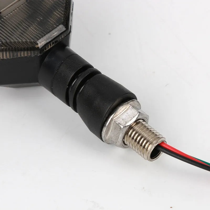 Arrow-shaped LED motorcycle turn signal indicator light with 12V connector.