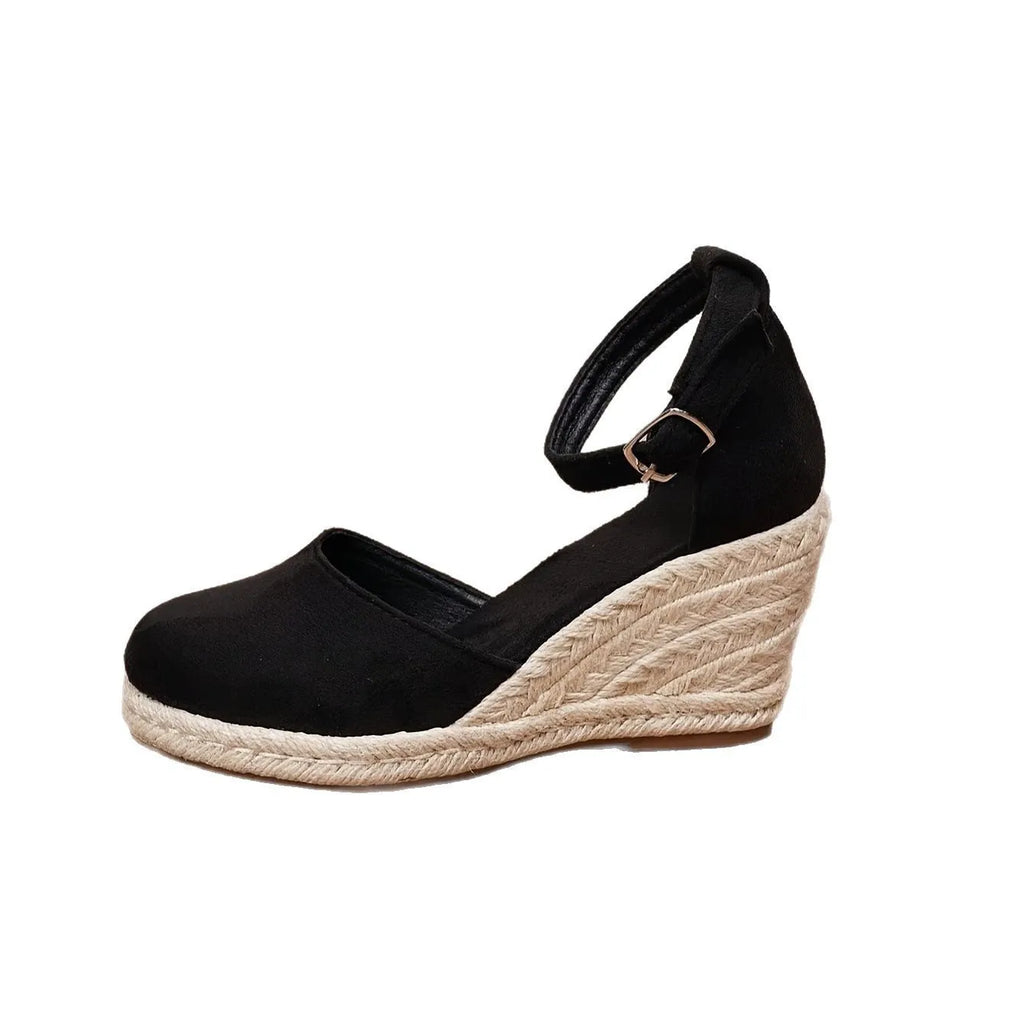 Women's apricot suede wedge sandals with a round toe and buckle strap on a rubber sole.