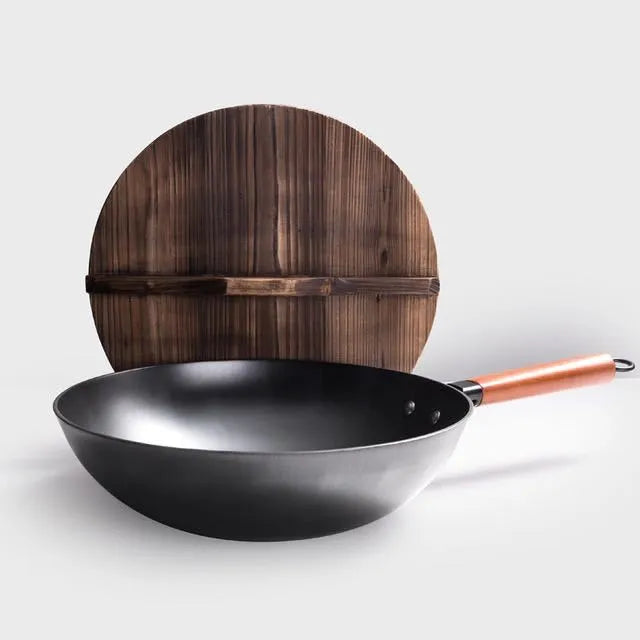 Black traditional iron wok with wooden handle measuring 32cm diameter