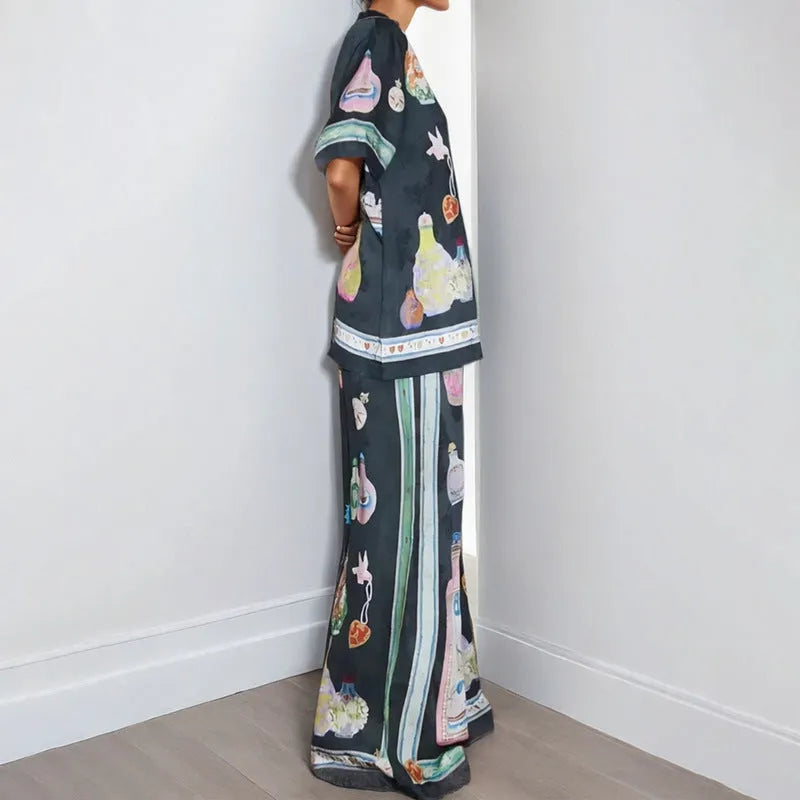 Black women's two-piece cardigan and trousers set with a cartoon animation pattern print.