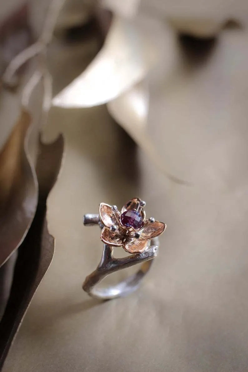 Silver two-tone floral geometric women's alloy ring on a plain background.