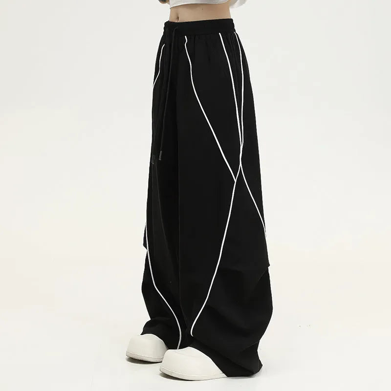 Black pleated wide-leg hip hop trousers with stripe pattern showing loose fit design