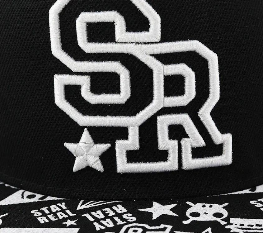 Black cotton baseball cap with white letter embroidery on the front, showing adjustable strap.