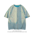 Men's blue loose-fit distressed short-sleeve t-shirt with ripped fabric detailing on a casual backdrop.