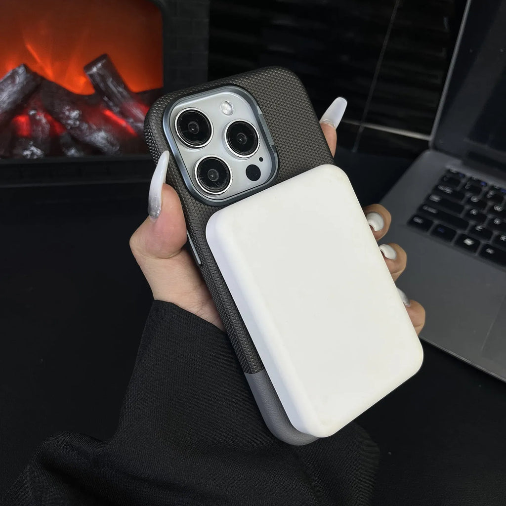 Black magnetic iPhone case with dragon scale texture and stitching, shown on an iPhone 15 Pro.