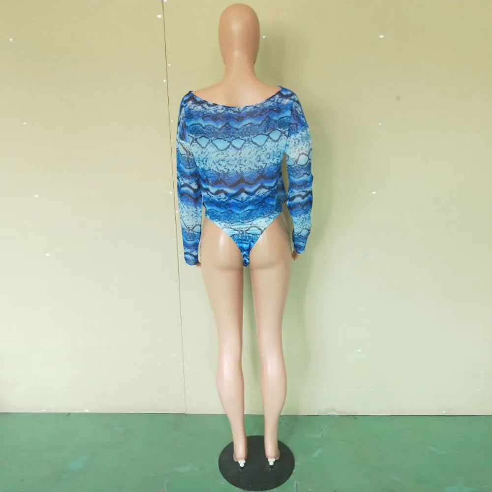 Women's snakeskin print polyester three-piece bikini suit showing long sleeve top, shorts and matching bottoms