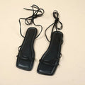 Women's flat sandals with an ankle ring bandage cloth strap and front lace-up fastening in orange.