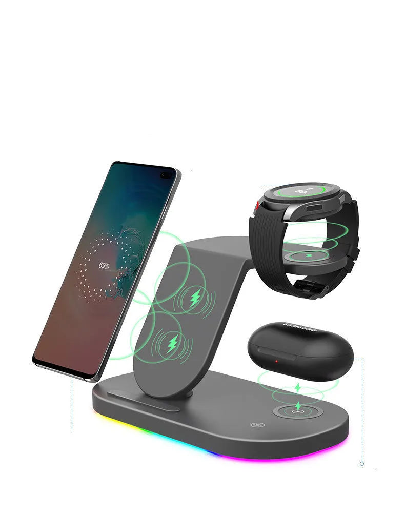Three-in-one wireless charging station in black, charging a mobile phone, a smartwatch, and wireless headphones.