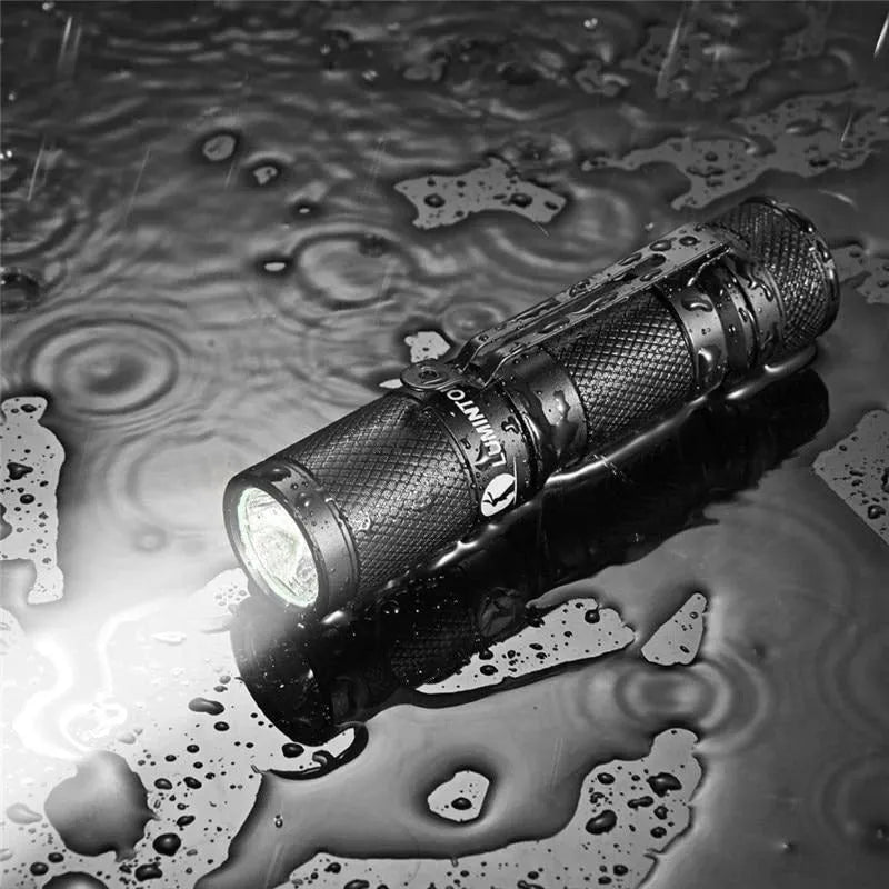 Black Lumintop Tool AA 2.0 aluminium keychain flashlight with magnetic tail cap and diffuser accessory.