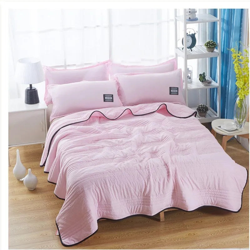 Pure colour seersucker cooling air-conditioning quilt laid flat on a bed