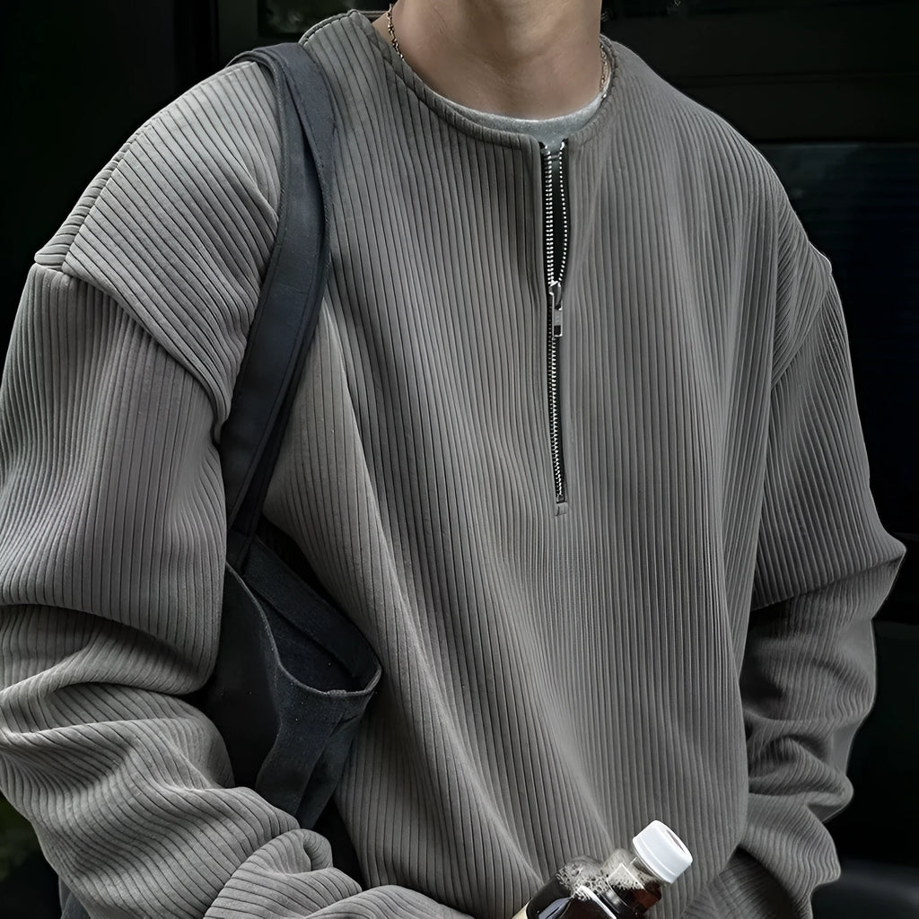 A solid colour loose pullover top with long sleeves, shown in apricot, grey and black.