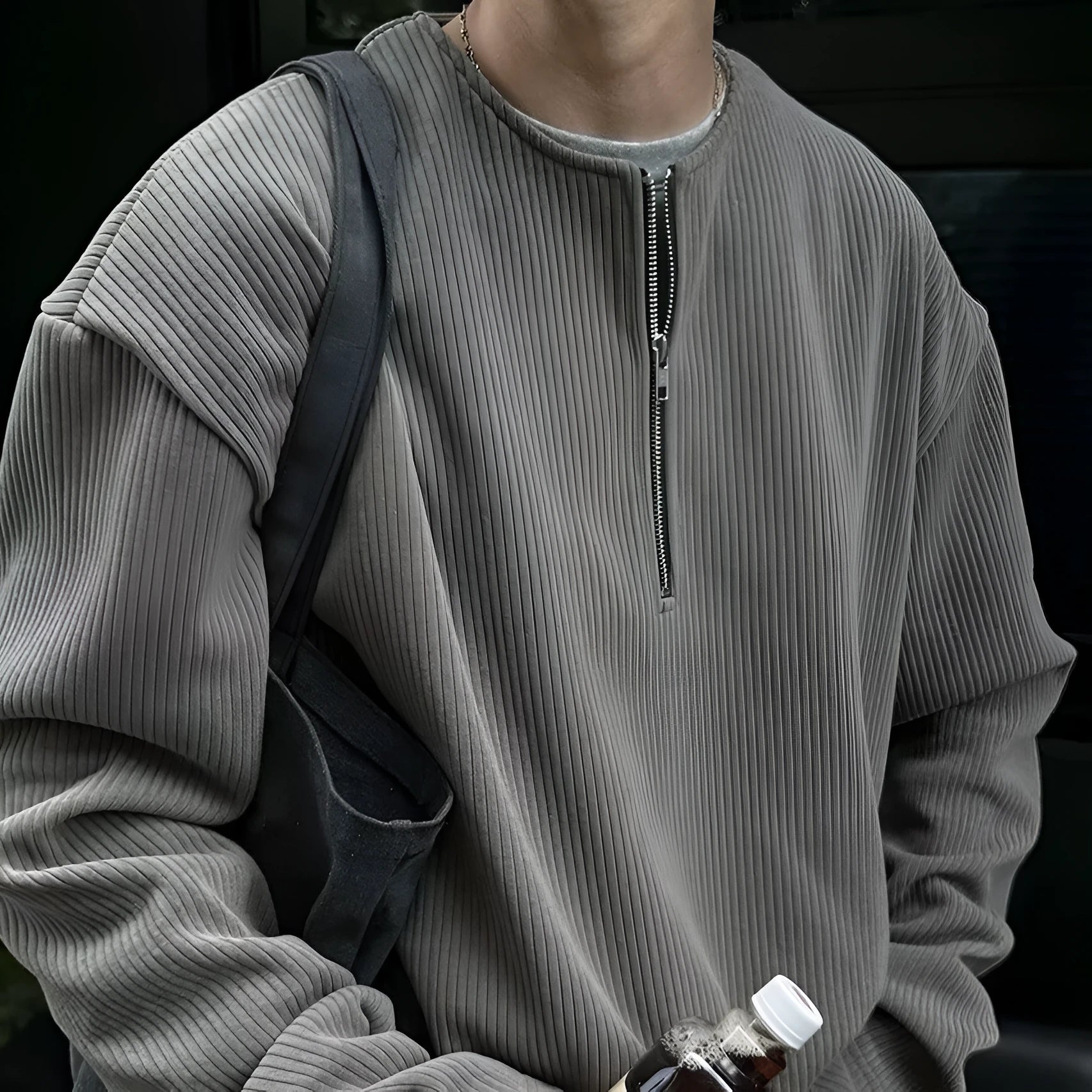 A solid colour loose pullover top with long sleeves, shown in apricot, grey and black.