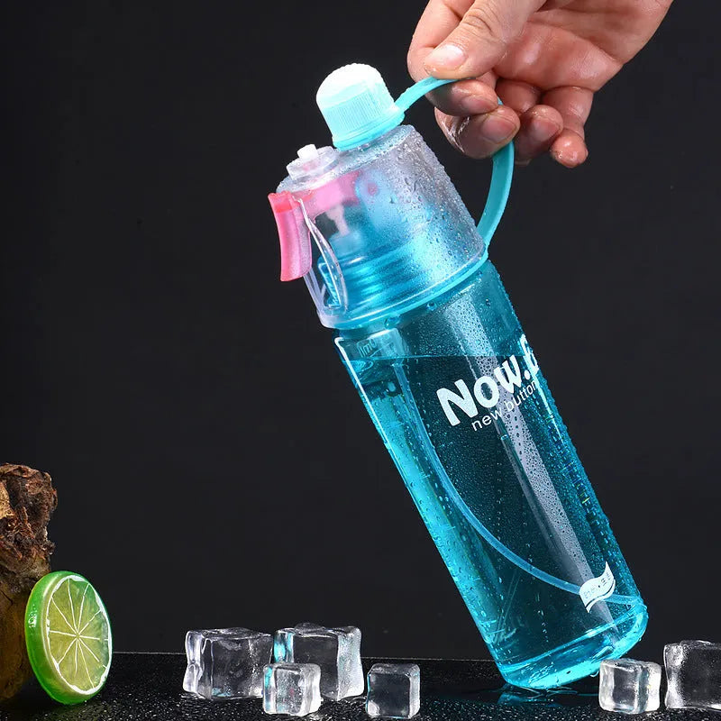 Portable outdoor sports mist spray cup with handle, transparent body showing scale markings, and spray mouth
