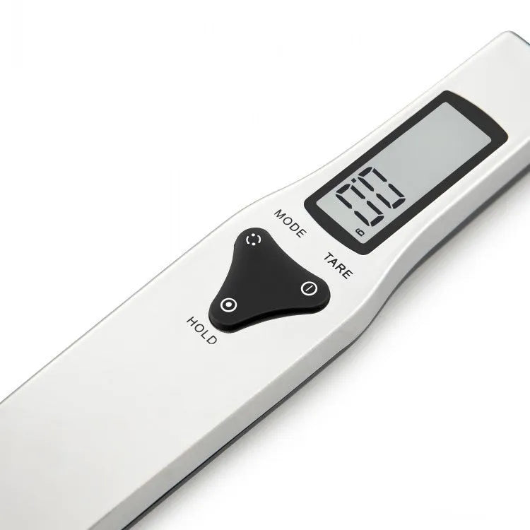 Smart digital measuring spoon with LCD display showing weight, used as a kitchen scale for food ingredients.