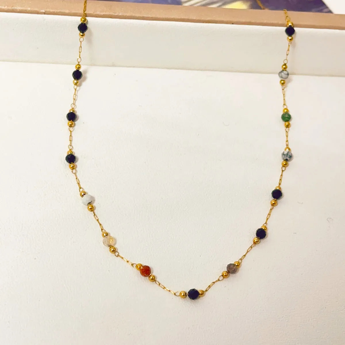 Gold titanium steel necklace with a natural stone pendant on an O-ring chain.