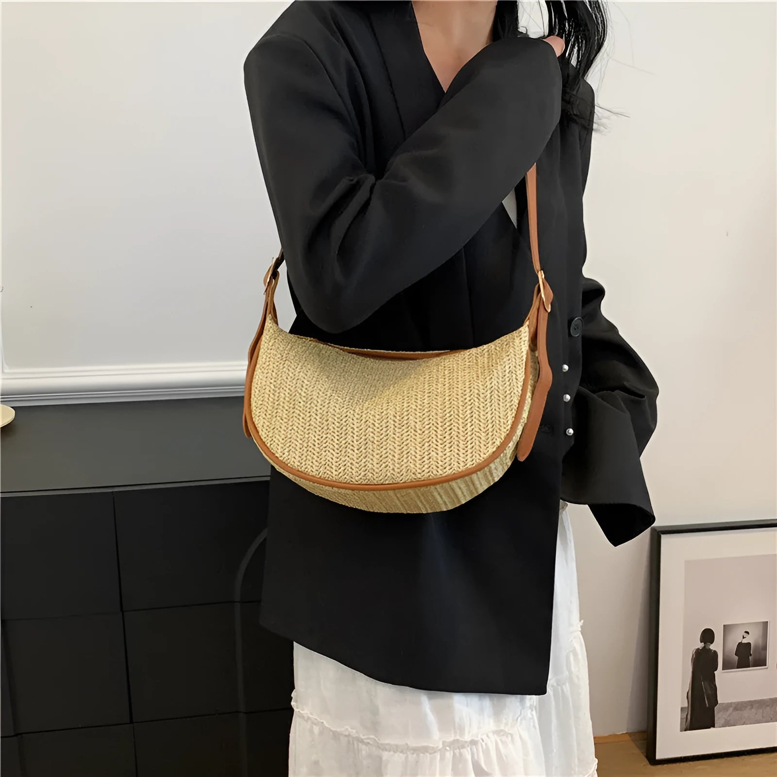 Women's woven straw crossbody bag showing internal phone pocket and file compartment in corrugated black colour