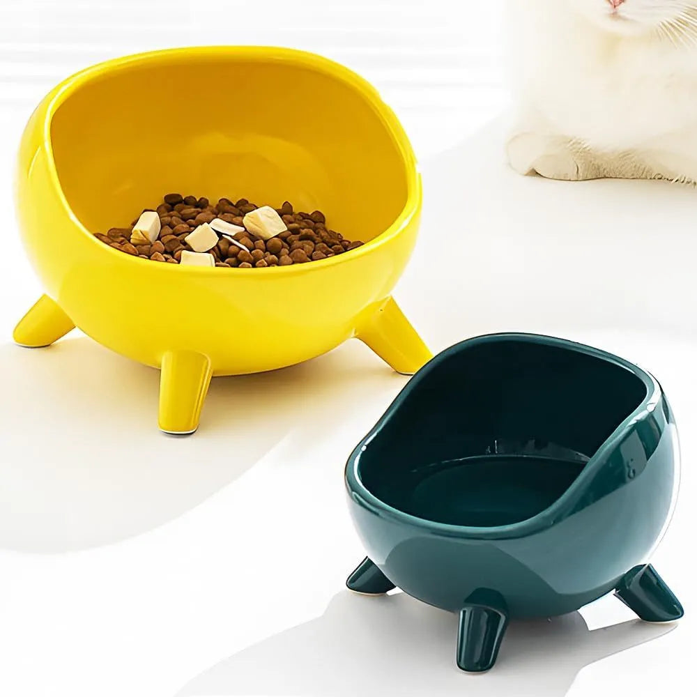 Green ceramic pet bowl with four legs and a rounded rim for stability and spill control.