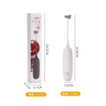Black and white hand-held electric milk frother blender on kitchen counter