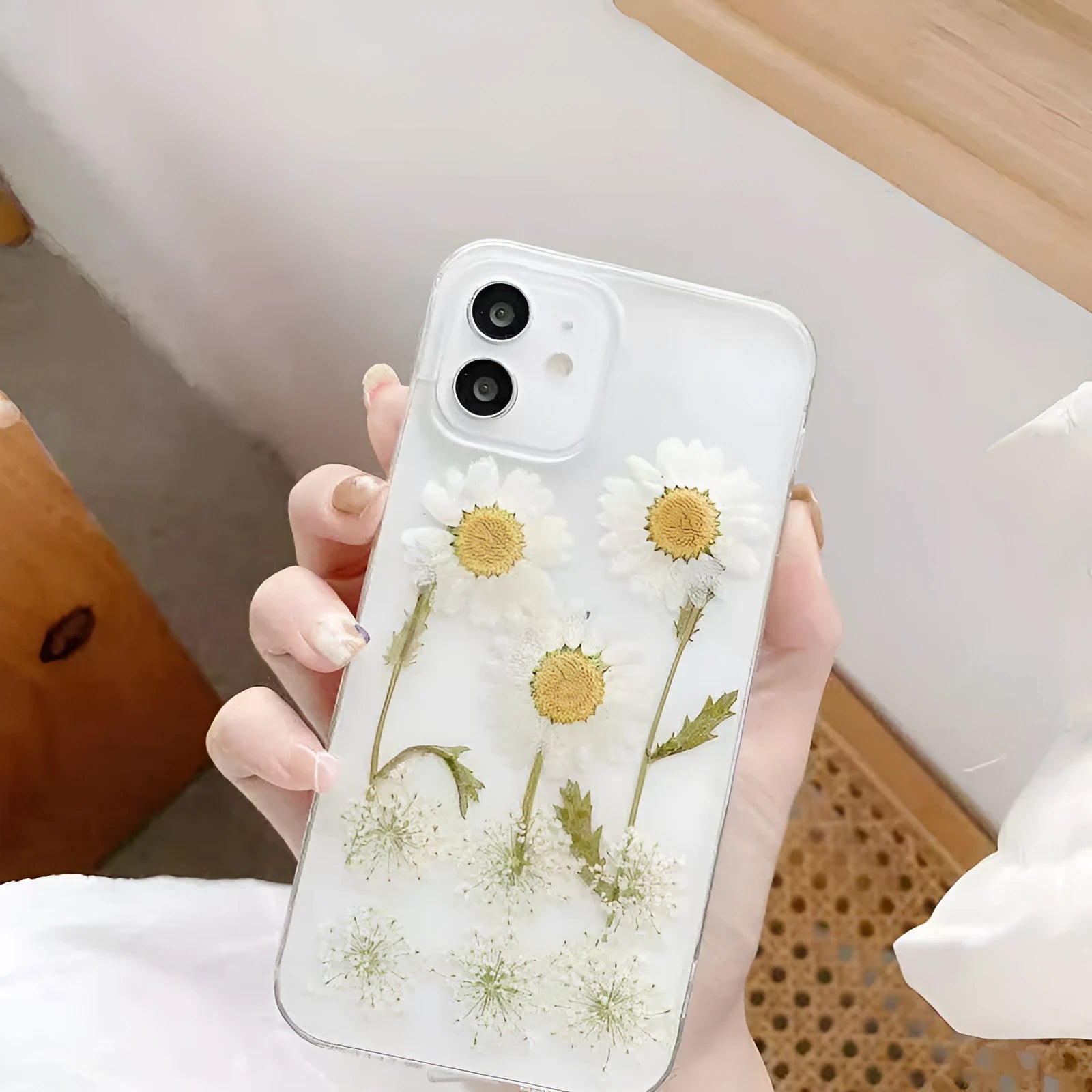 White TPU iPhone case with a raised epoxy daisy flower design on the back