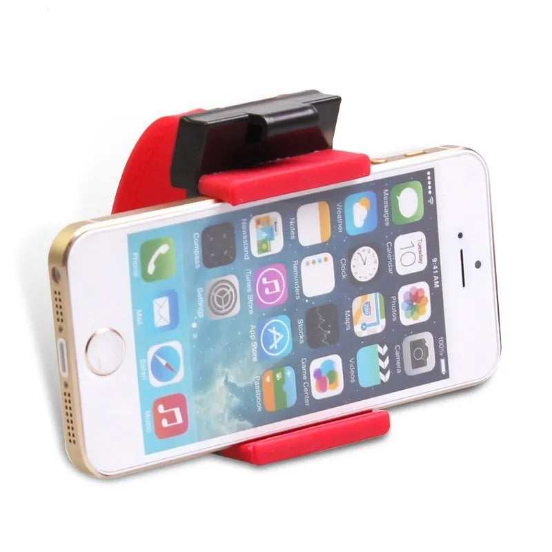 Black universal steering wheel phone holder clip mounted on a car steering wheel holding a smartphone.