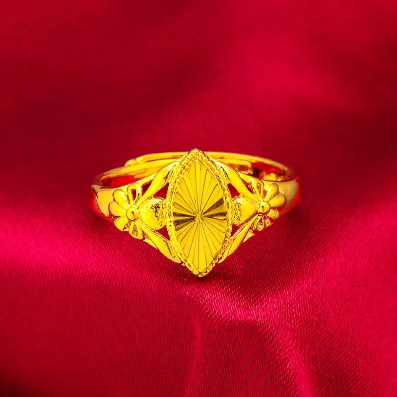 Gold openwork geometric flower ring with a textured alluvial pattern on a brass base.