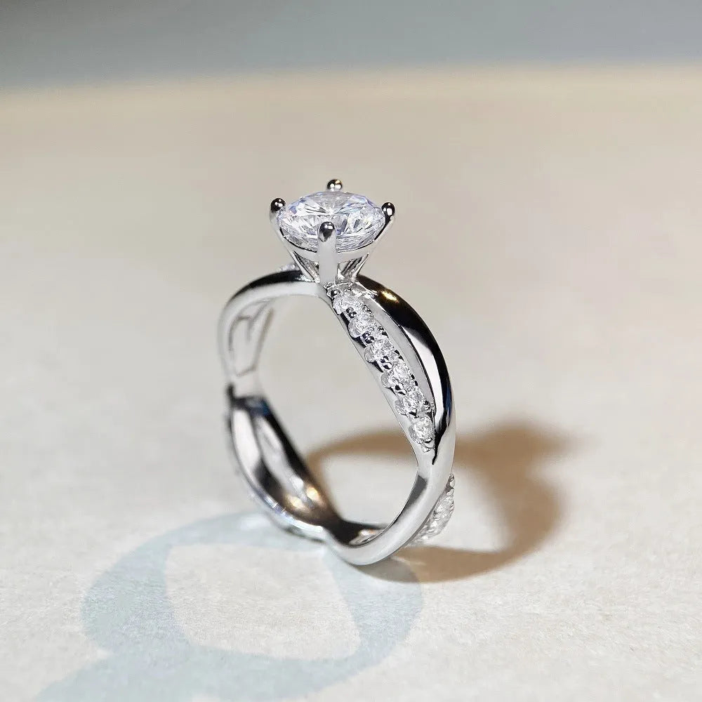 Geometric twist arm silver ring with 1 karat moissanite stone in four-claw winding setting