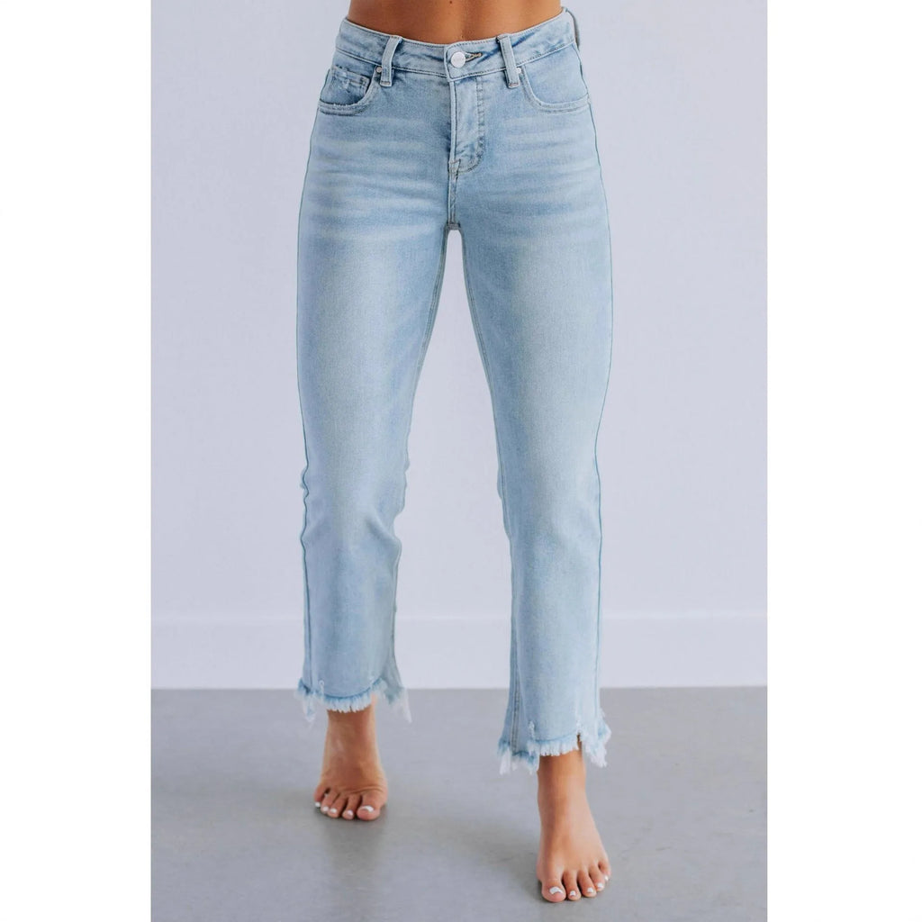 Women's dark blue cotton denim jeans with hand-worn distressing detail on the front.