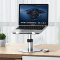 Silver adjustable aluminium car laptop stand with rotating base on a car seat.