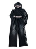 Man wearing a black punk-print hooded pullover jumpsuit with long sleeves and fleece lining.