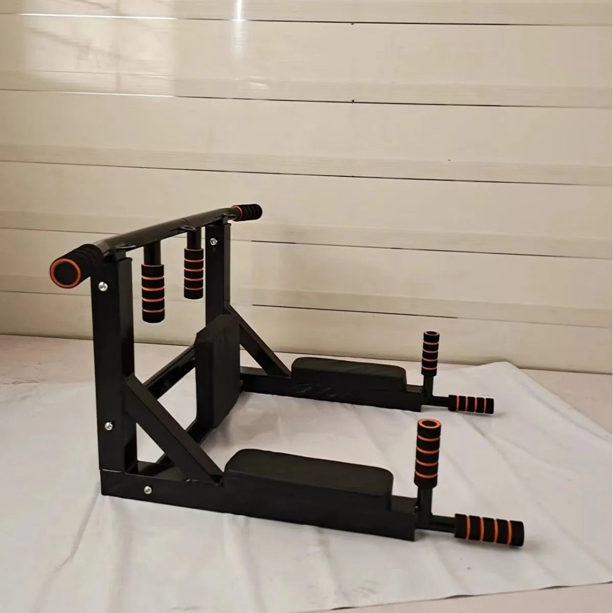 Black wall-mounted fitness equipment with sandbag rack and single parallel bars