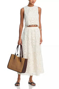 White women's two-piece suit with sleeveless top and embroidered long skirt