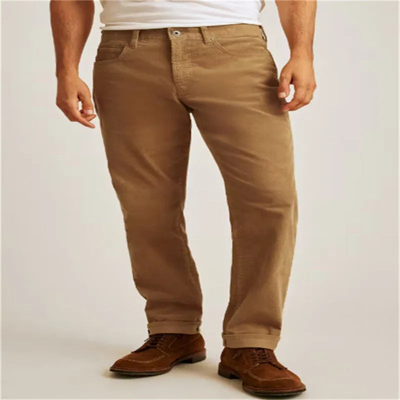A pair of loose straight-leg corduroy trousers in an army green colour, laid flat.