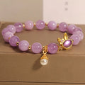 Purplish red mauve jade rabbit head charm on a crystal adjustable Mori-style bracelet.